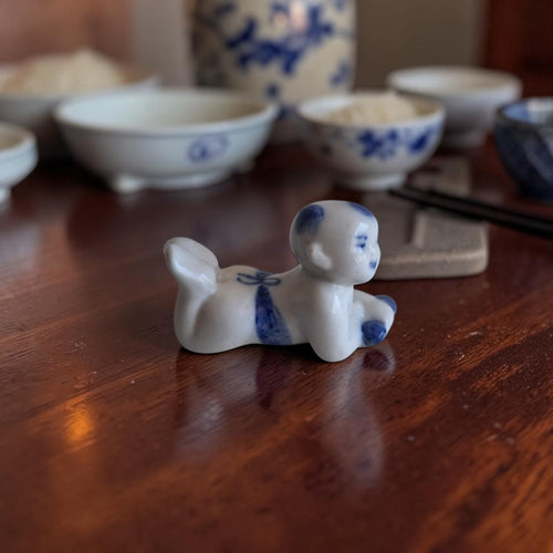 Chinees blauw-wit porseleinen miniatuurbeeldje van een kruipende Karako jongen, hoogte ca. 4 cm, eetstokjeshouder of decoratief object.