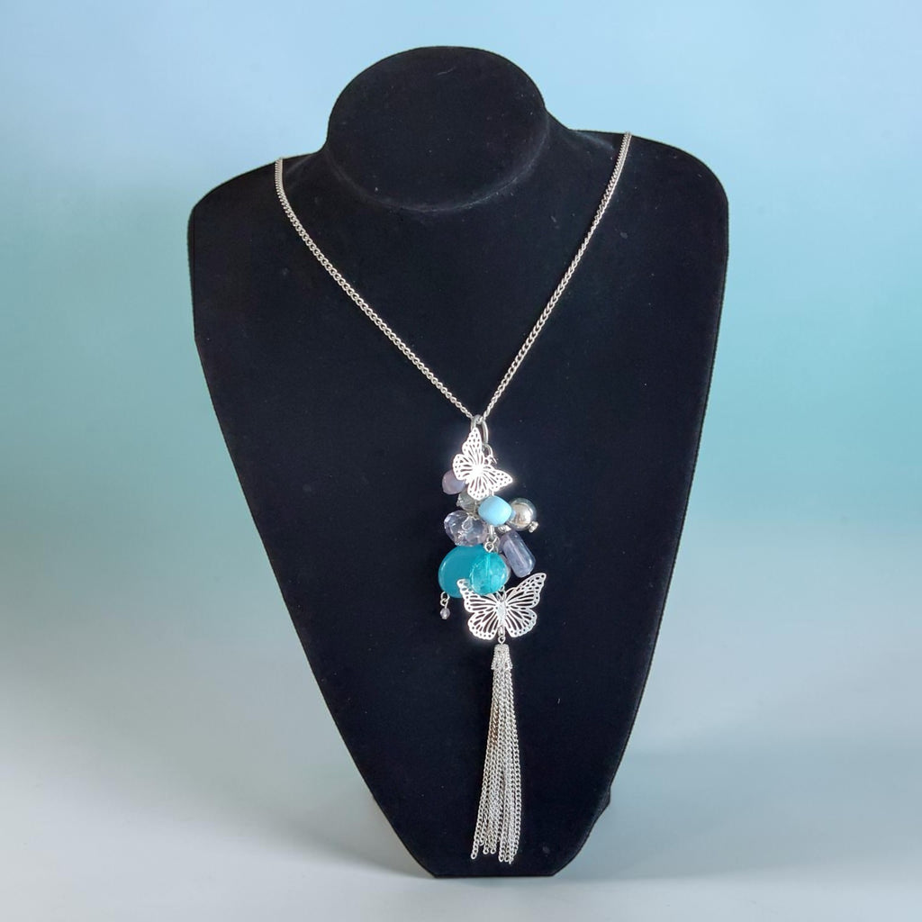 Lange zilveren halsketting met turquoise en grijze kralen, twee sierlijke zilveren vlinders en een elegante kettingkwast, 86 cm.