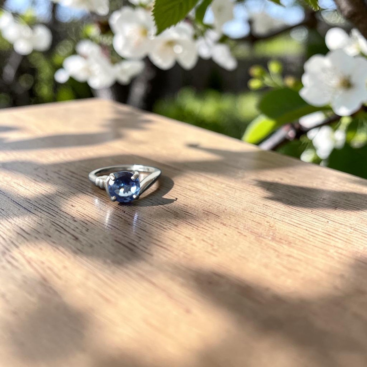 Vintage verzilverde solitaire damesring in koper met ronde lichtblauwe steen en asymmetrische zetting, binnenmaat 17,5 mm
