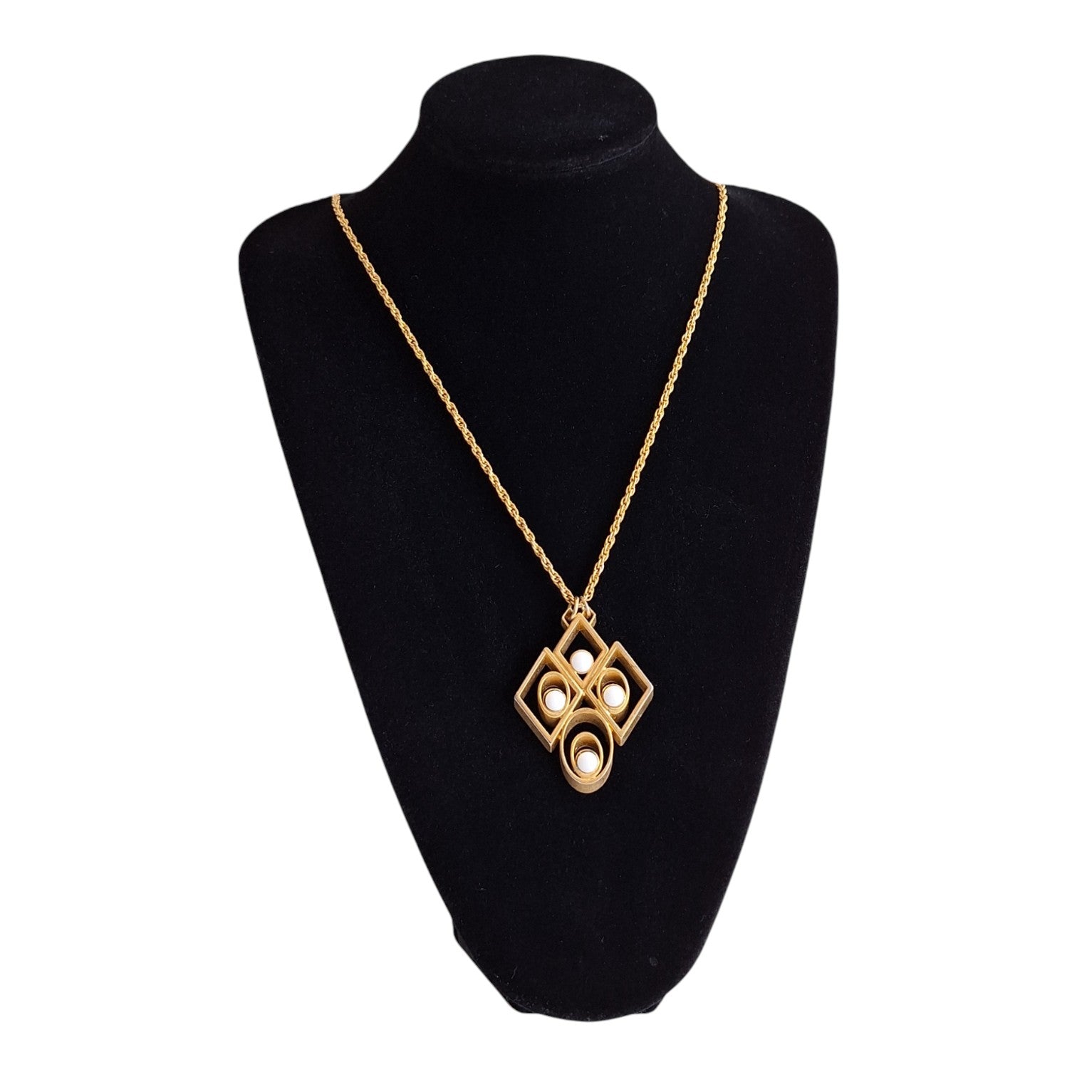 gold-coloured necklace with an abstract pendant