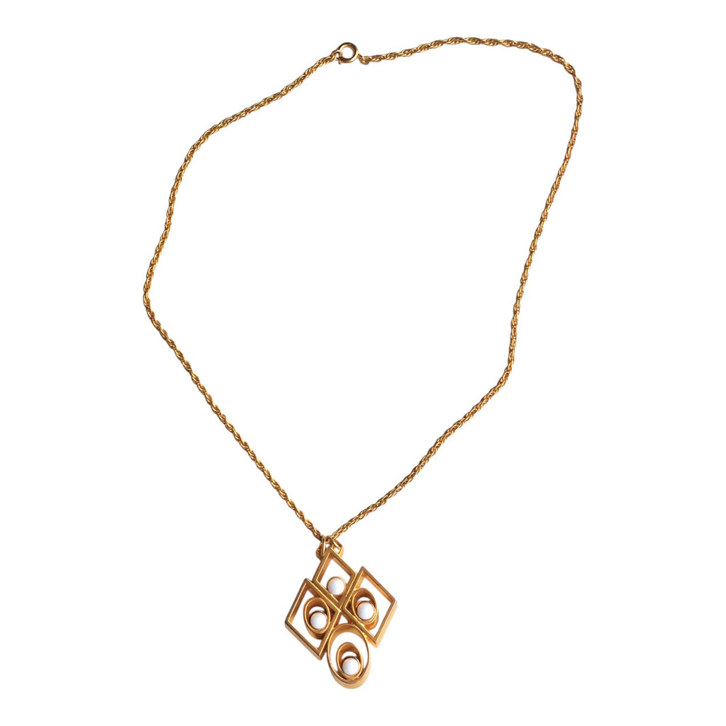 gold-coloured necklace with an abstract pendant