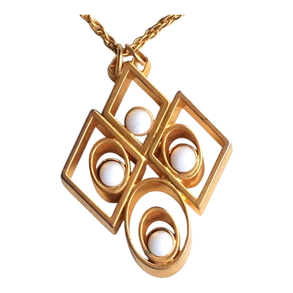 gold-coloured necklace with an abstract pendant