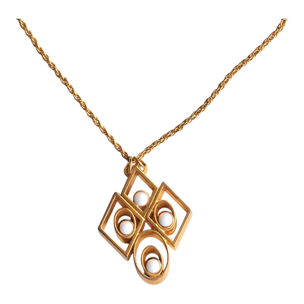 gold-coloured necklace with an abstract pendant