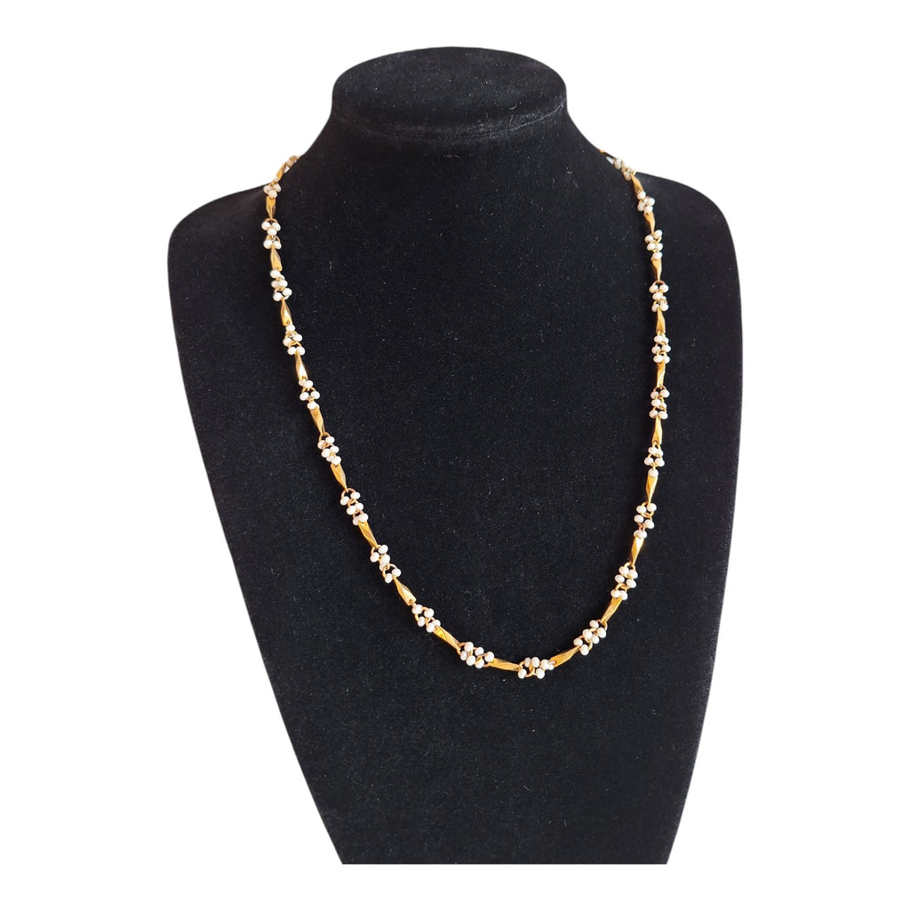 Gold-colored necklace with white beads