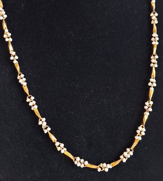 Gold-colored necklace with white beads