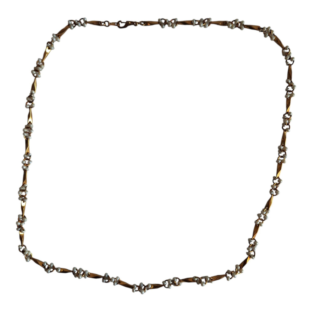 Gold-colored necklace with white beads