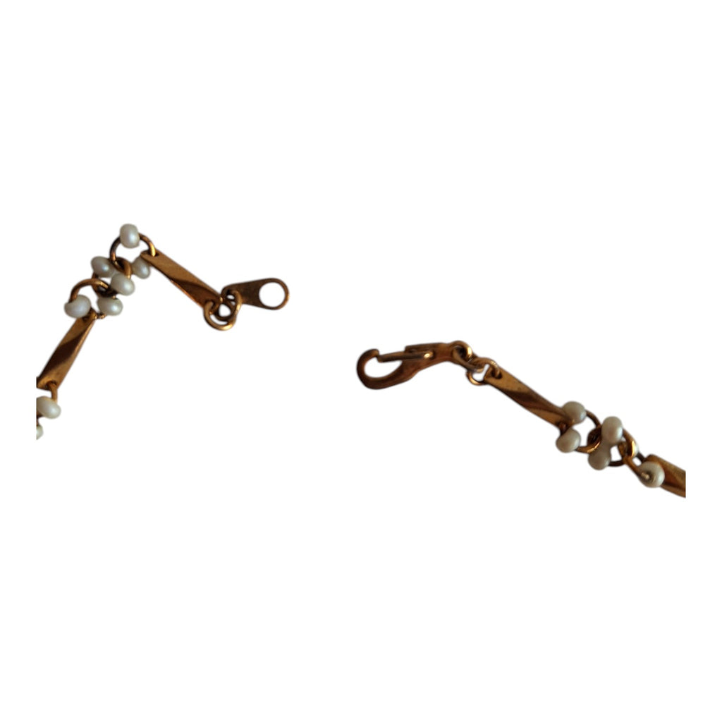 Gold-colored necklace with white beads
