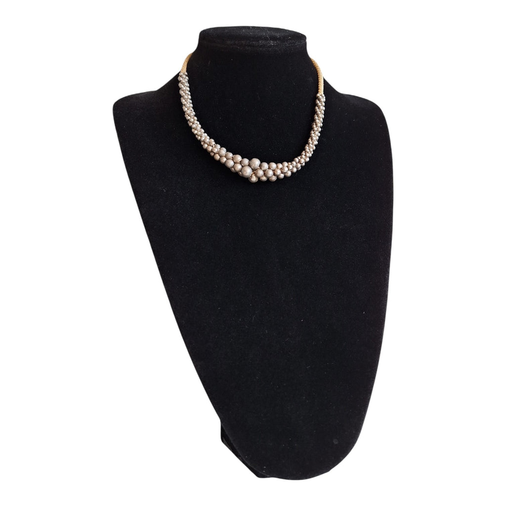 Silver-colored beads strung on a cord