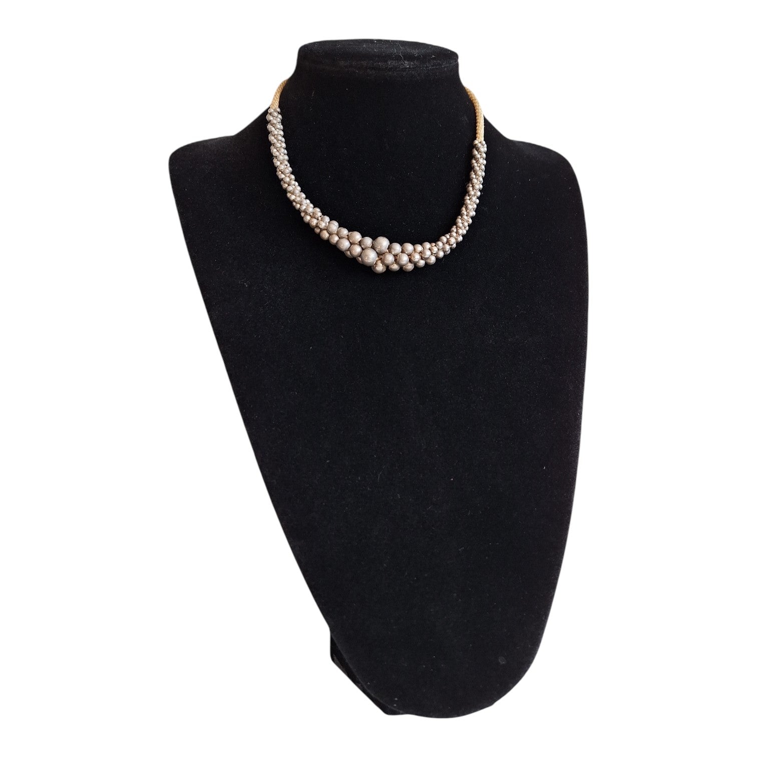 Silver-colored beads strung on a cord