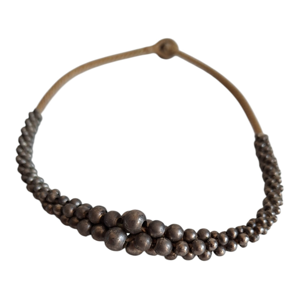 Silver-colored beads strung on a cord