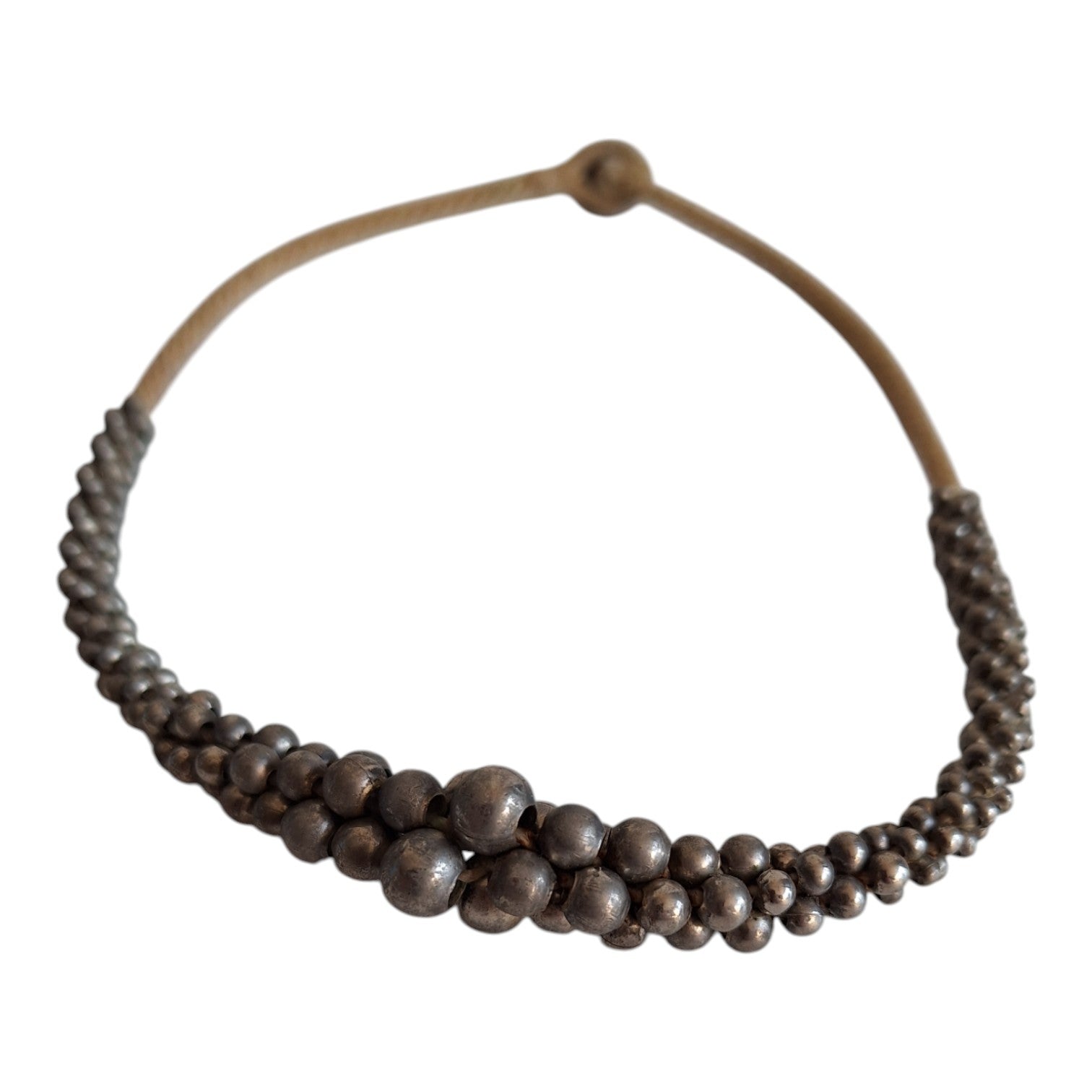 Silver-colored beads strung on a cord
