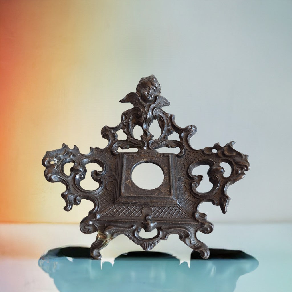 2nd Hand Bargain antique ornate cherub metal clock frame with dark aged finish and scrollwork.
