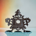 2nd Hand Bargain antique ornate cherub metal clock frame with dark aged finish and scrollwork.
